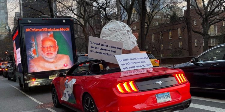 New York display: oversized Modi puppet in convertible with provocative banner 1 New York display: oversized Modi puppet in convertible with provocative banner