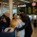 Indian family at a Canadian airport arrivals hall, Canada super visa processing time Indians 2026