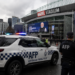 AFP warns a young person about an online threat to Modi. Melbourne Meets Modi proceeds on schedule. 7 Australian Federal Police vehicle outside Marvel Stadium, Melbourne Meets Modi visit security AFP warning 2026