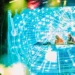 A DJ duo performing under coloured blue, green and red stage lighting at a live venue, representing the Brampton Punjabi live music scene