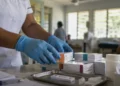 Healthcare worker arranging HIV antiretroviral medication and testing supplies at a Pacific clinic amid Fiji's HIV national emergency