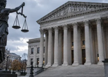New $103,265 H-1B Fee Alarms Indian Tech Workers 3 Scales of justice before a federal courthouse, symbolizing the H-1B visa fee 2026 litigation