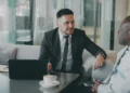 Two professionals in a mentoring-style conversation at a small table, illustrating an Indian business network Melbourne founders can turn to for support