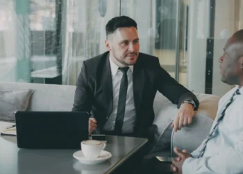 Indian Business Network Melbourne: A Critical Lifeline After Six Lonely Years 3 Two professionals in a mentoring-style conversation at a small table, illustrating an Indian business network Melbourne founders can turn to for support