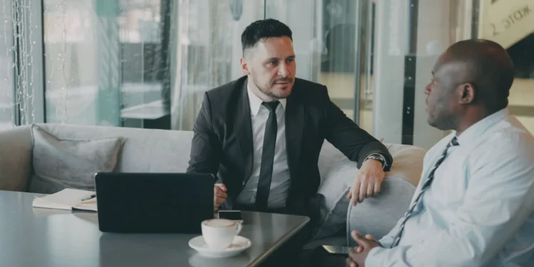Indian Business Network Melbourne: A Critical Lifeline After Six Lonely Years 1 Two professionals in a mentoring-style conversation at a small table, illustrating an Indian business network Melbourne founders can turn to for support