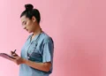 Indian Nurse Canada Recognition: A Critical 5-Year Wait Despite a Faster BC Option 11 A nurse in scrubs with a stethoscope writing on a clipboard, representing the credential review an Indian nurse completes for Canada registration