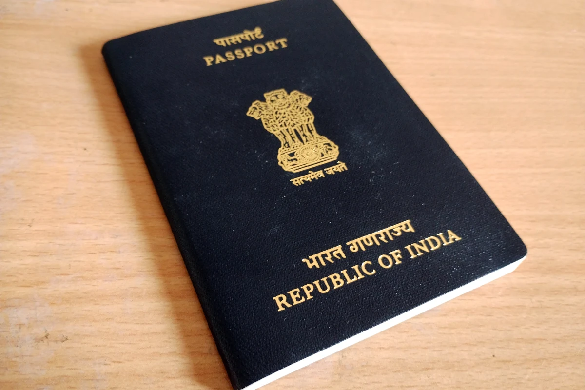 The cover of an Indian passport on a wooden surface
