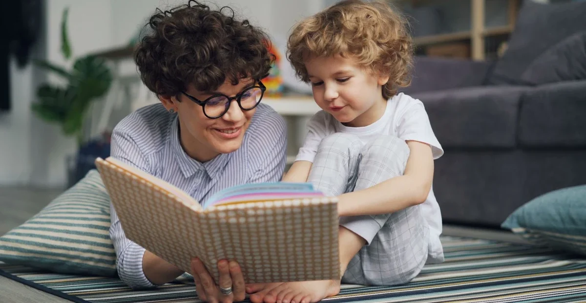 Adult and child reading together, illustrating home language activities