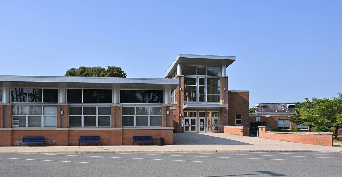 Woodson High School entrance in Virginia illustrating US school enrolment
