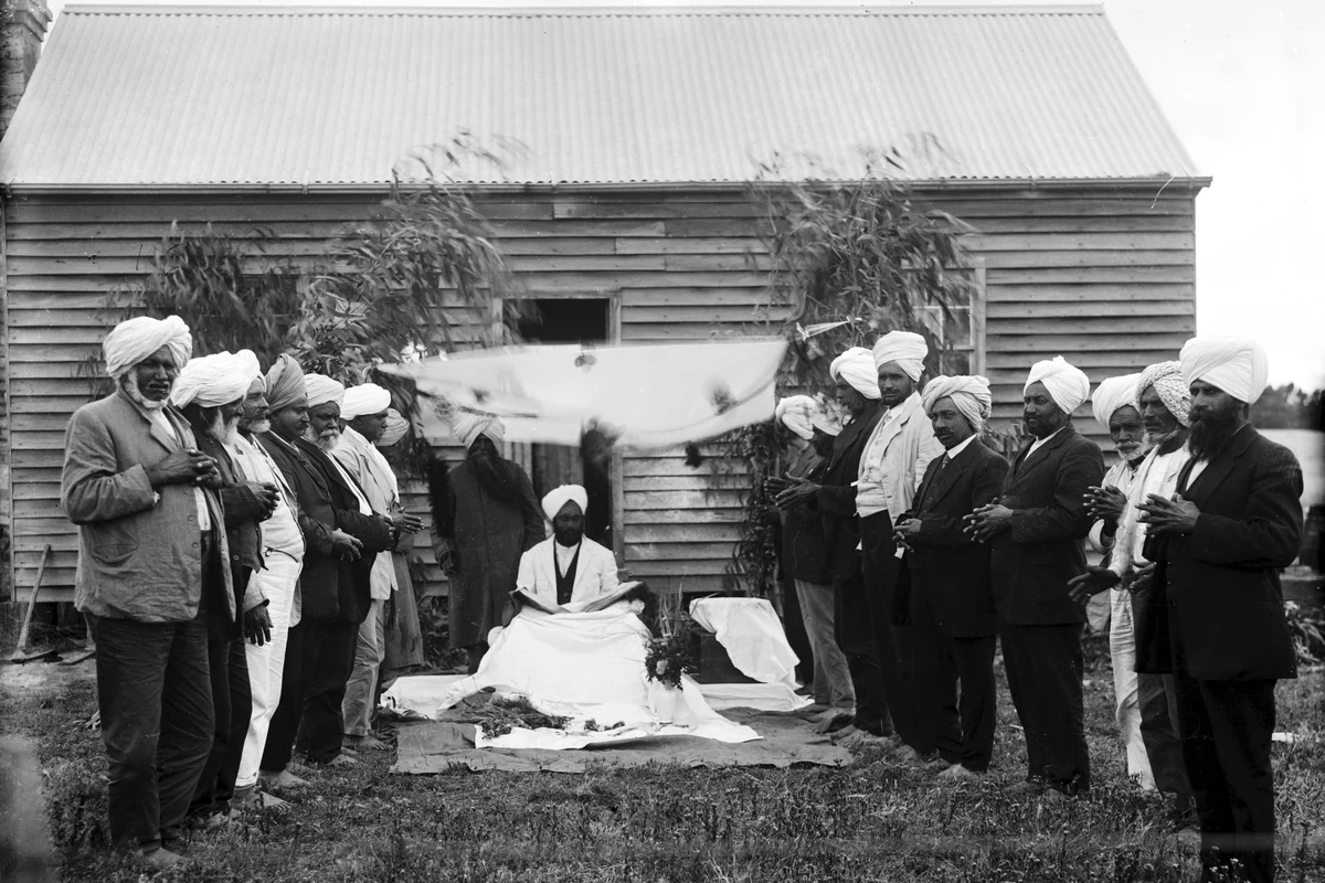 Congregation standing outside the timber cottage at Reef Hills in 1920